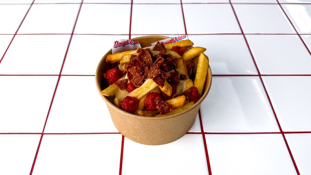 A tub of Dough Club loaded fries topped with pepperoni crumb and pizza sauce