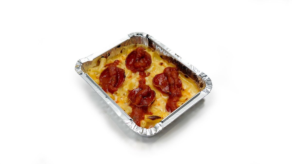 A tray of Dough Club mac & cheese topped with pepperoni and pizza sauce