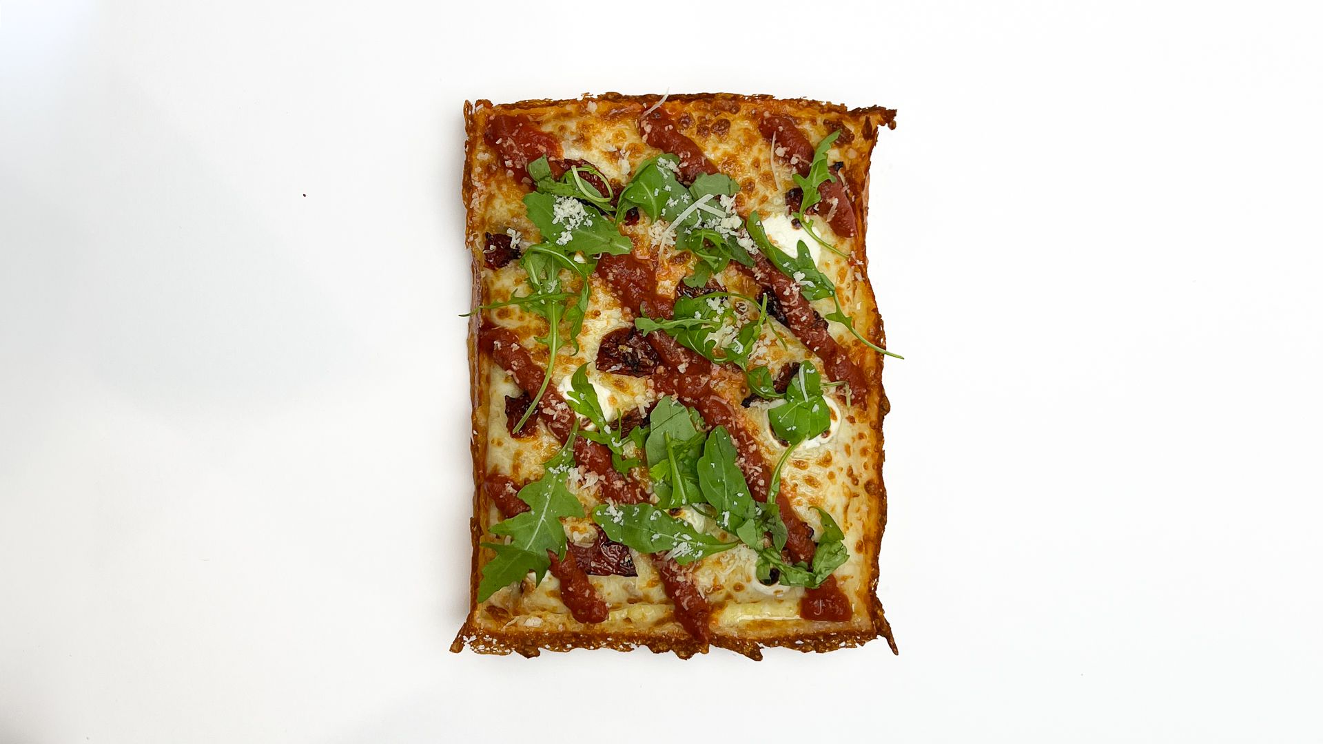 A Dough Club Margarita Deluxe pan pizza from above, sundried tomatoes, mascarpone and rocket
