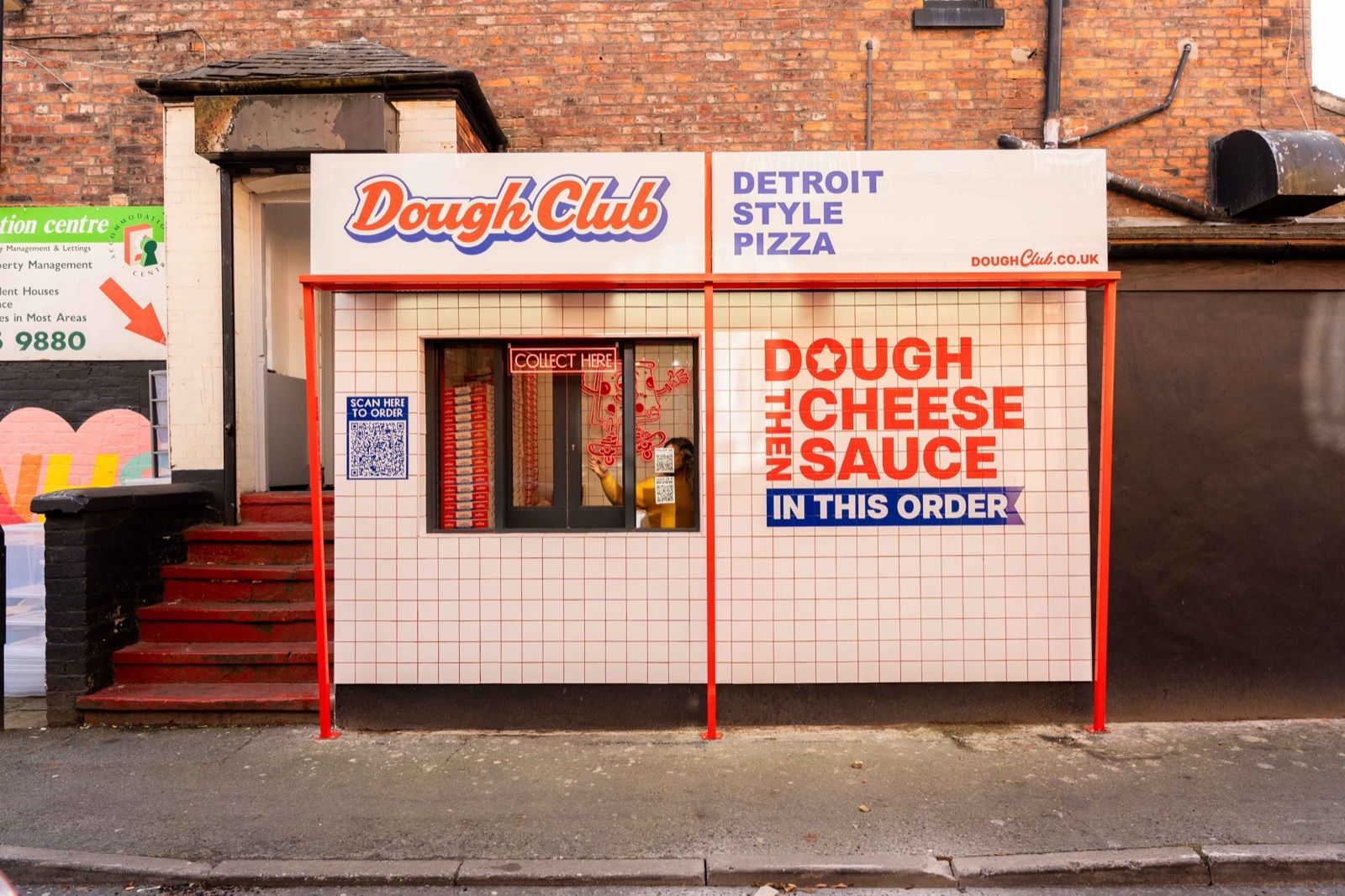 The Dough Club shopfront in Withington, its window signage spelling out dough, cheese, then sauce, in this order